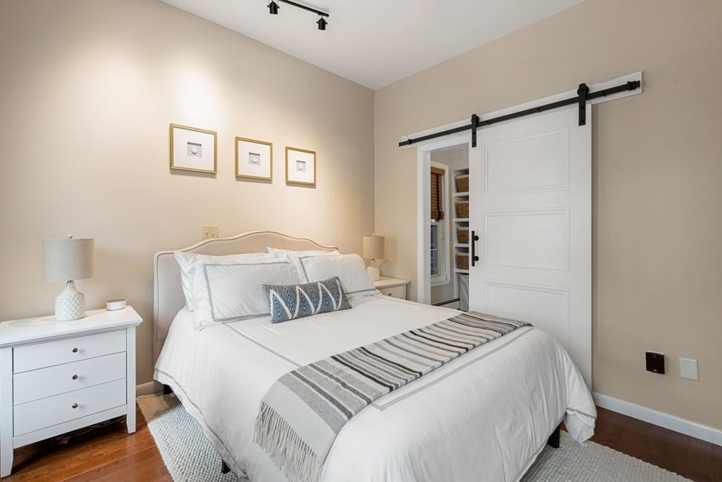 52 O Street, Unit 3 Boston, MA 02127 - Photo 7 of 15 a bedroom with a bed and a walk in closet