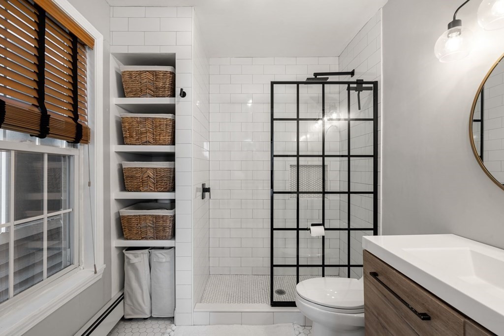 52 O Street, Unit 3 Boston, MA 02127 - Photo 8 of 15 a bathroom with a toilet a sink and a window