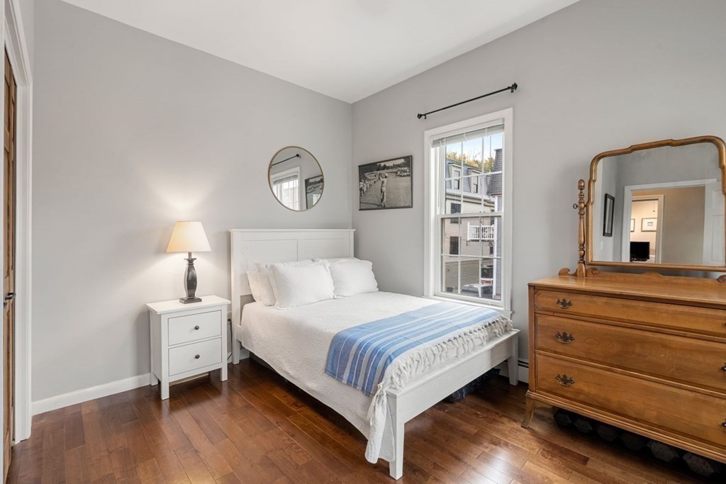 52 O Street, Unit 3 Boston, MA 02127 - Photo 9 of 15 a bedroom with a bed and a mirror