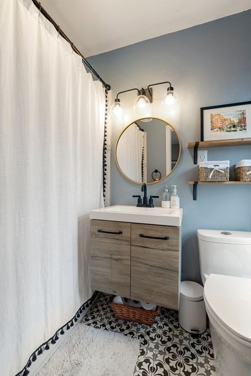 52 O Street, Unit 3 Boston, MA 02127 - Photo 10 of 15 a bathroom with a toilet a sink and a mirror