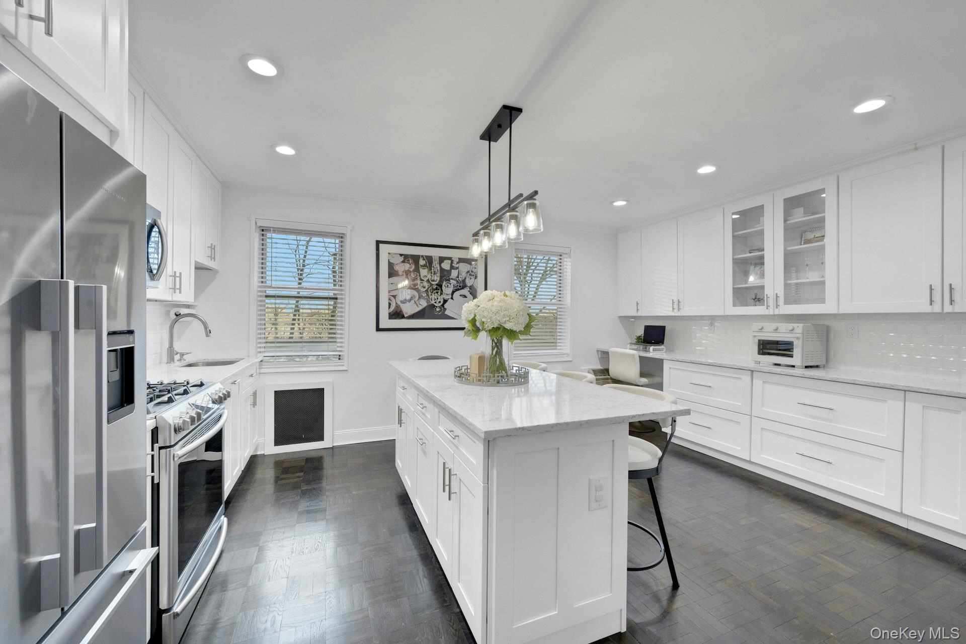 a kitchen with white cabinets and stainless steel appliances
