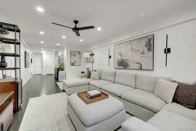 a living room with furniture and a ceiling fan