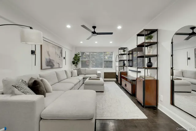 a living room with furniture and a book shelf