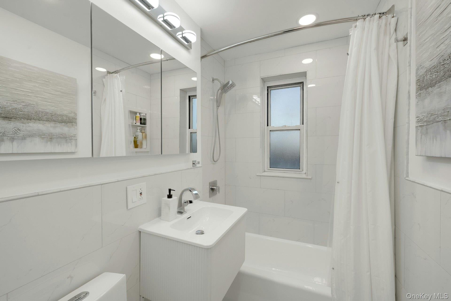 609 Palmer Road, Unit 2J Yonkers, NY 10701 - Photo 13 of 23 a bathroom with a sink a toilet and shower