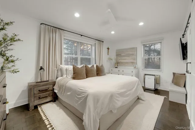 a bedroom with a large bed and a tv