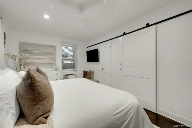 a bed sitting in a bedroom and tv