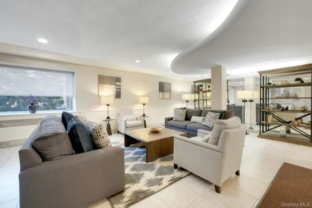 a living room with fireplace furniture and a large window