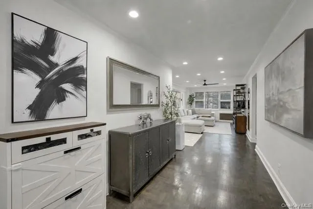a large kitchen with a lot of counter space and wooden floor