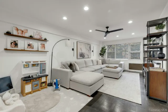 a living room with furniture and a book shelf