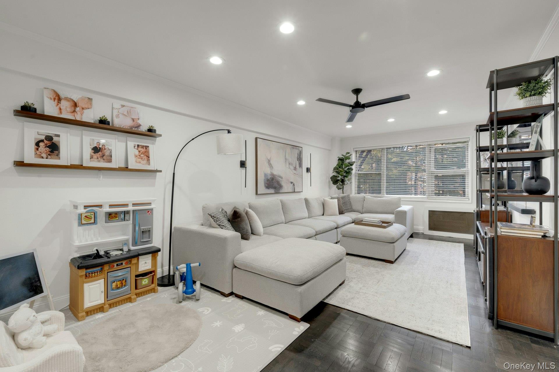 609 Palmer Road, Unit 2J Yonkers, NY 10701 - Photo 8 of 23 a living room with furniture and a book shelf