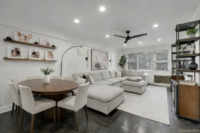 a living room with furniture and a book shelf