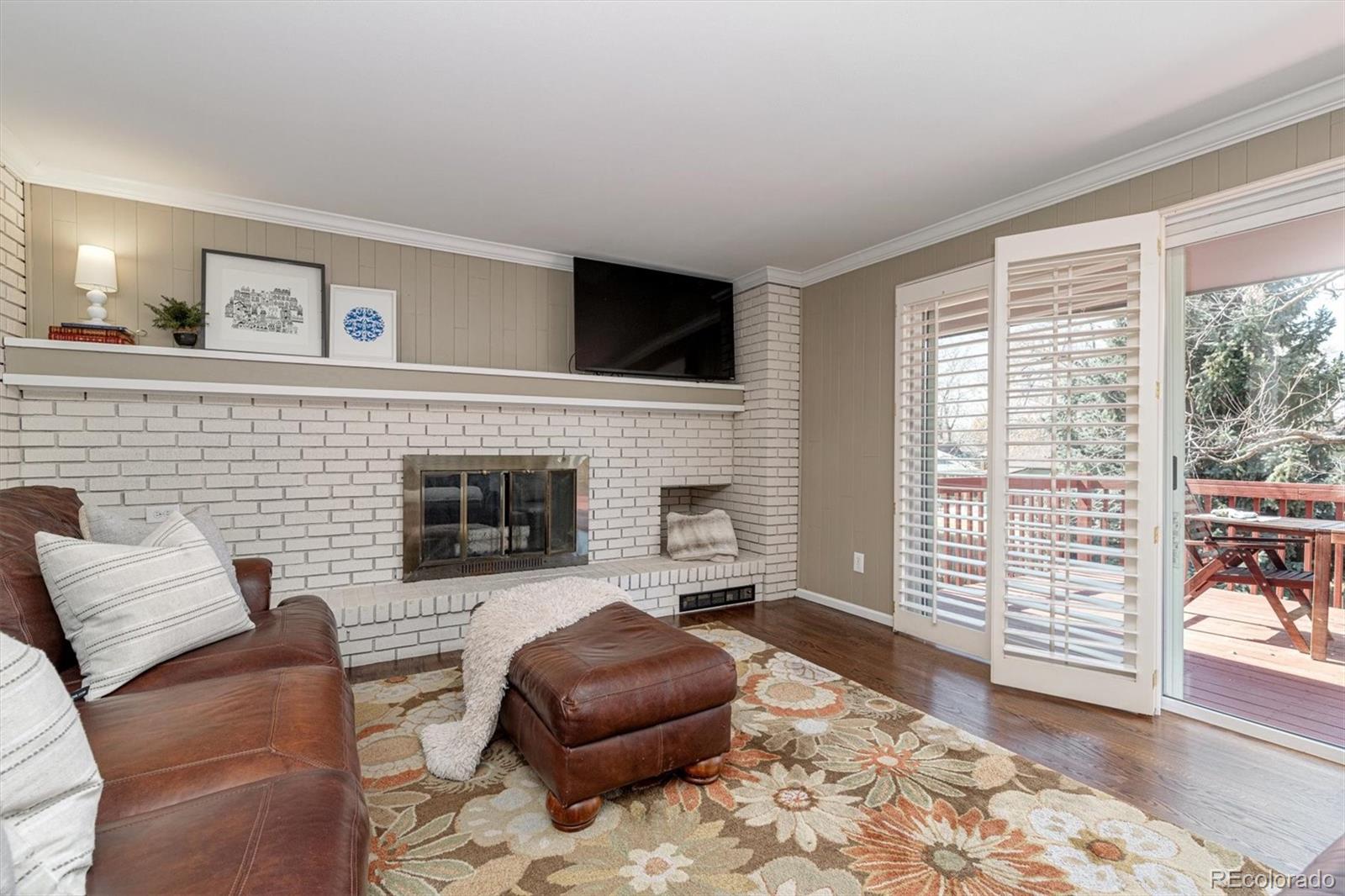 6145 South Eudora Way Centennial, CO 80121 - Photo 15 of 33 a living room with furniture a flat screen tv and a fireplace