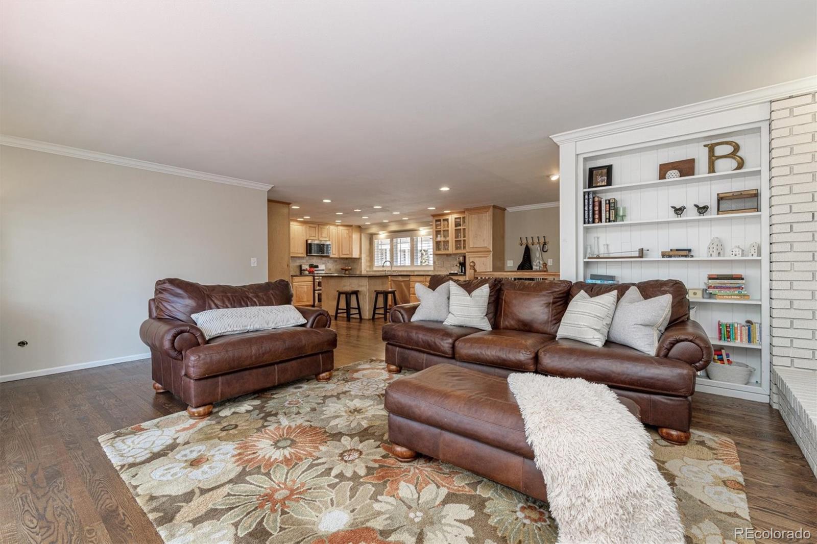 6145 South Eudora Way Centennial, CO 80121 - Photo 16 of 33 a living room with furniture or couch and a bookshelf