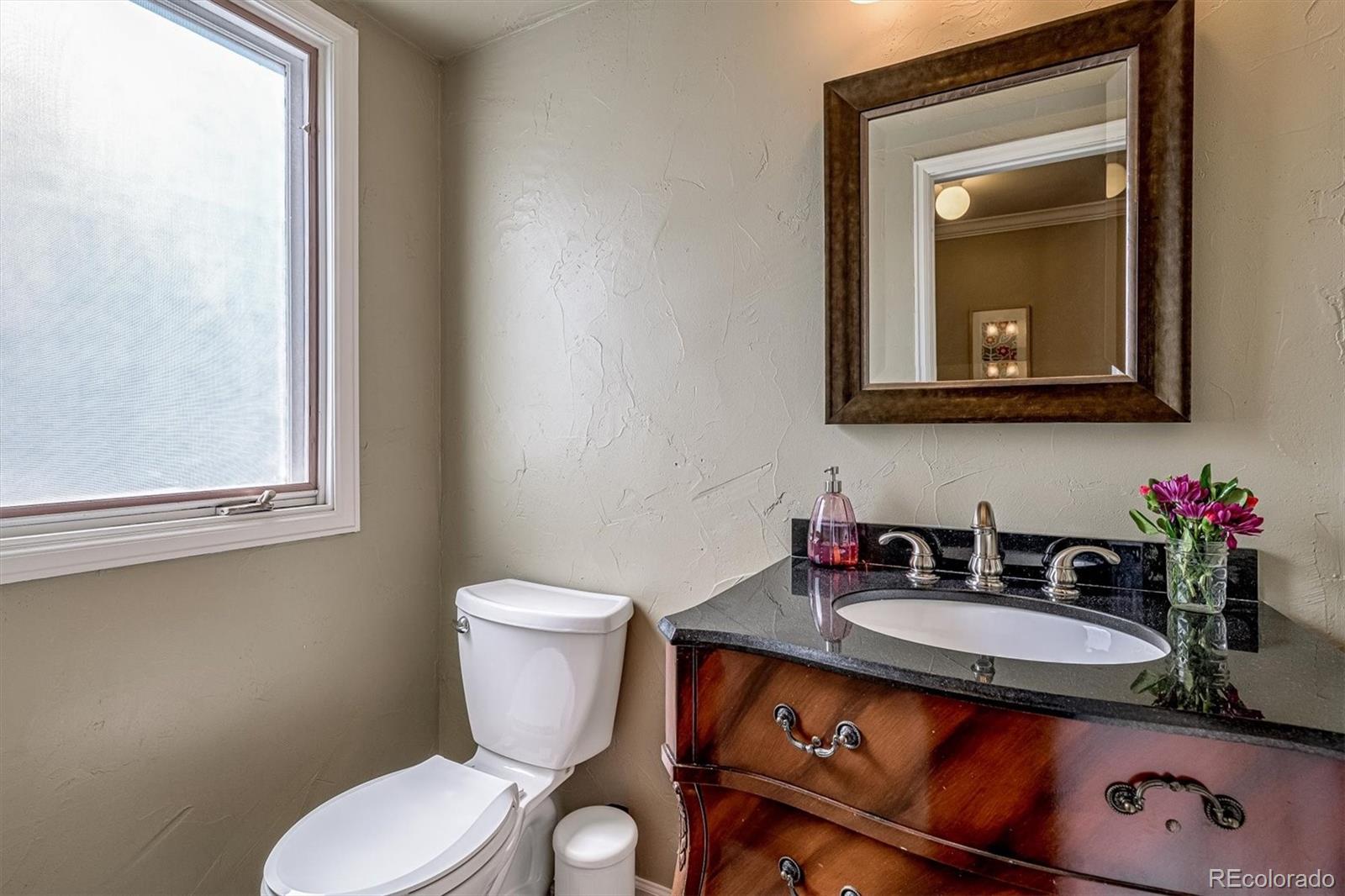6145 South Eudora Way Centennial, CO 80121 - Photo 17 of 33 a bathroom with a toilet sink and mirror