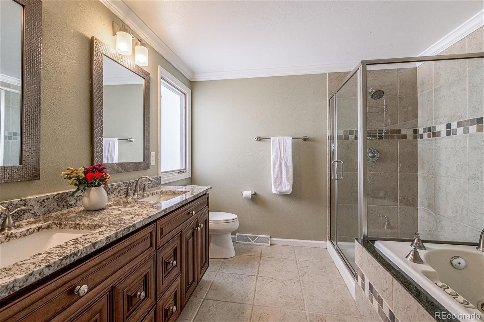 6145 South Eudora Way Centennial, CO 80121 - Photo 20 of 33 a bathroom with a granite countertop sink and a mirror