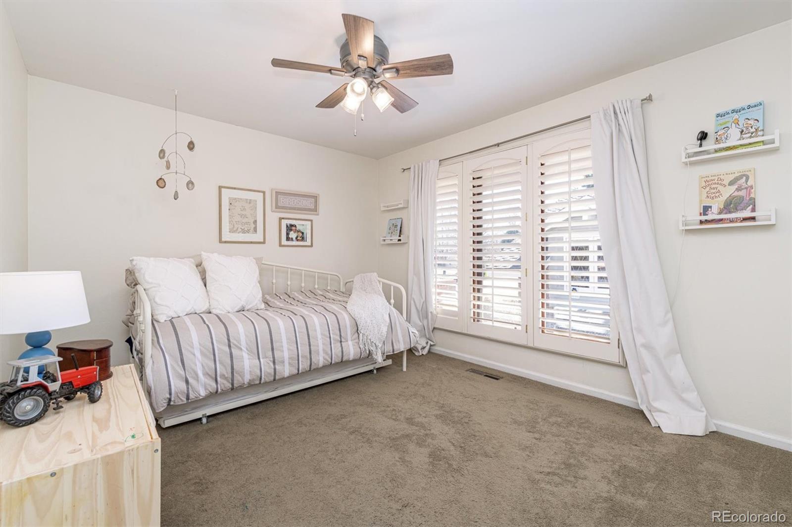 6145 South Eudora Way Centennial, CO 80121 - Photo 21 of 33 a spacious bedroom with a bed and a large window
