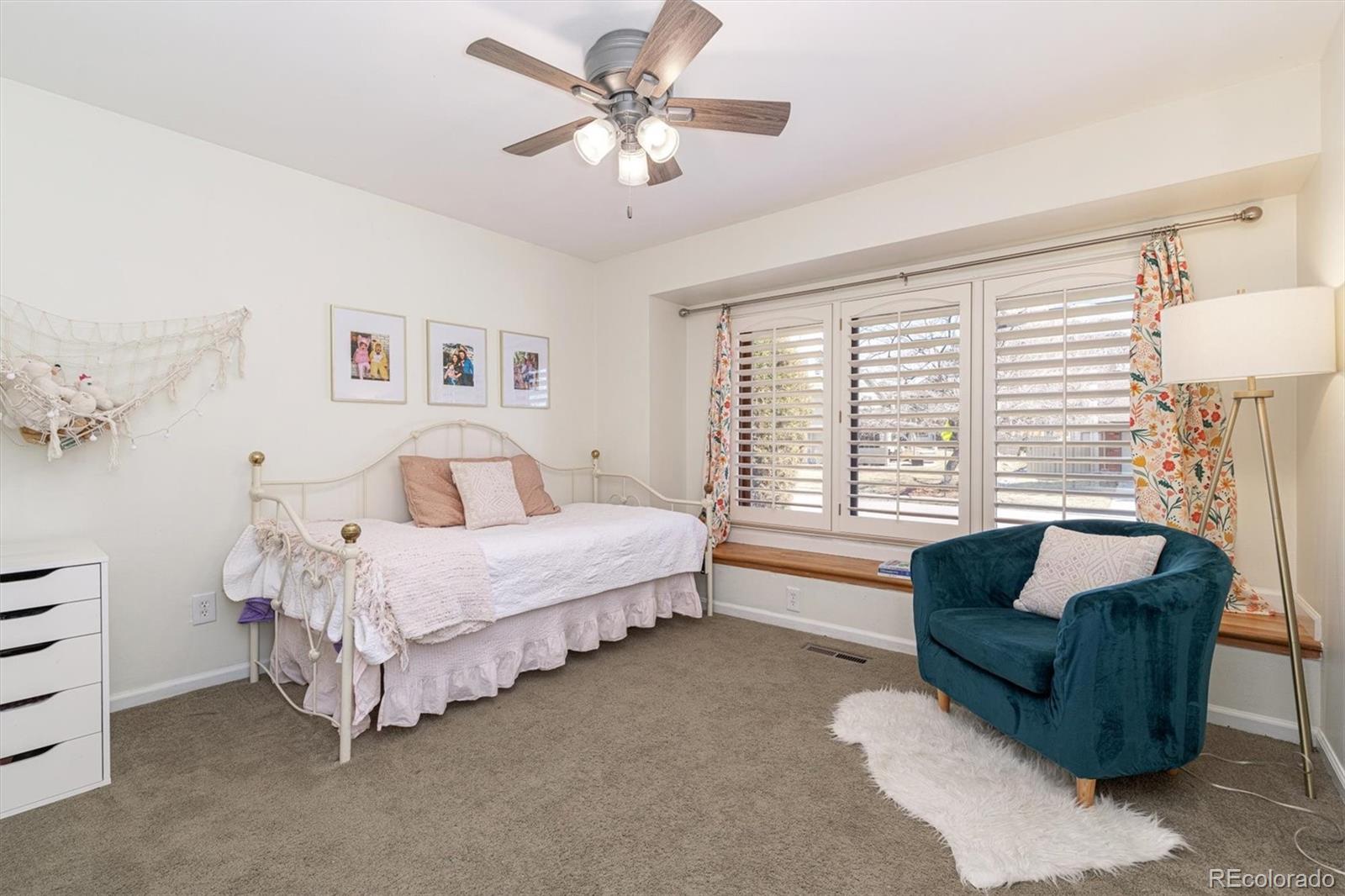 6145 South Eudora Way Centennial, CO 80121 - Photo 22 of 33 a spacious bedroom with a bed and a couch