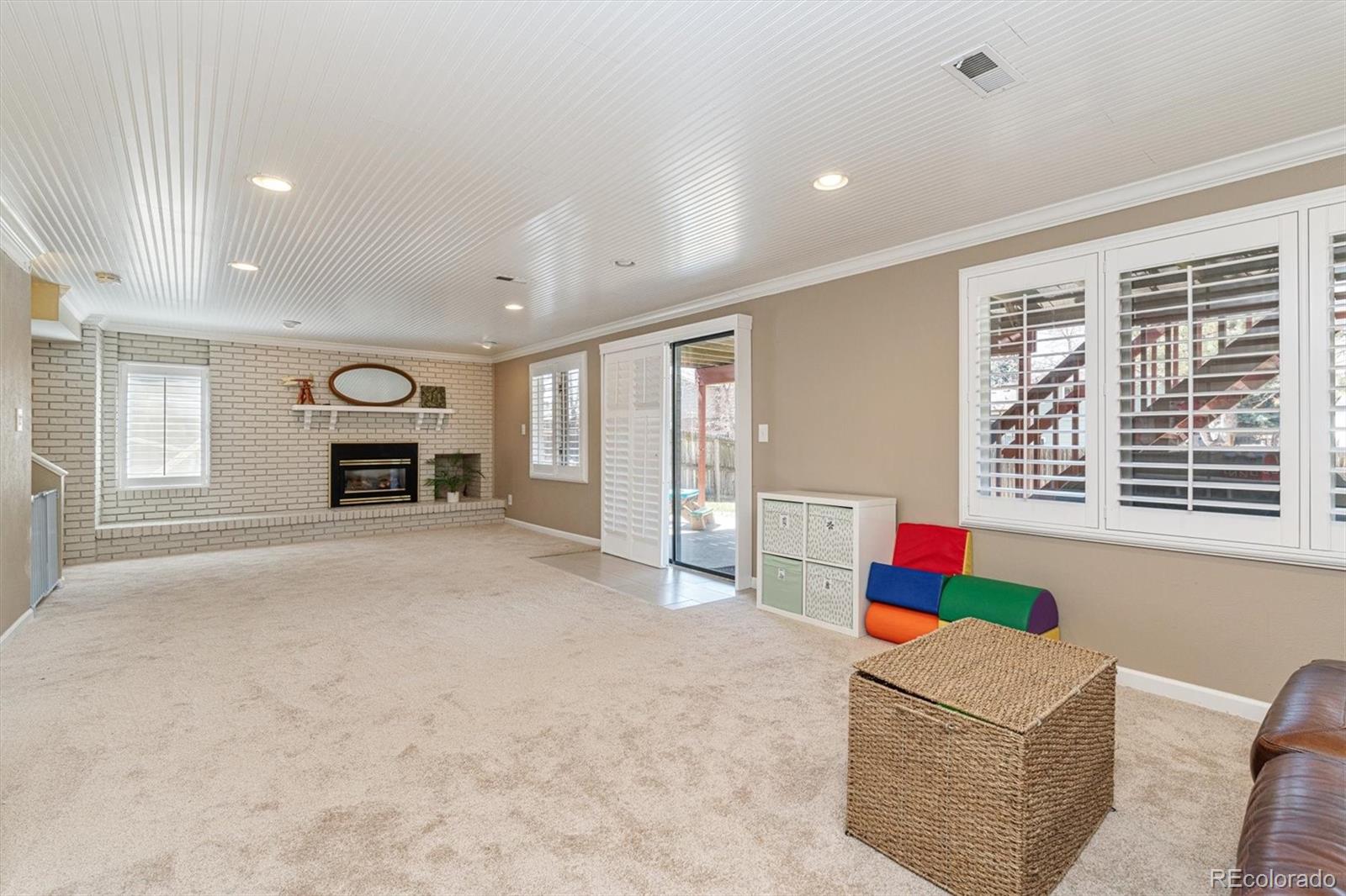 6145 South Eudora Way Centennial, CO 80121 - Photo 24 of 33 a living room with furniture and a fireplace
