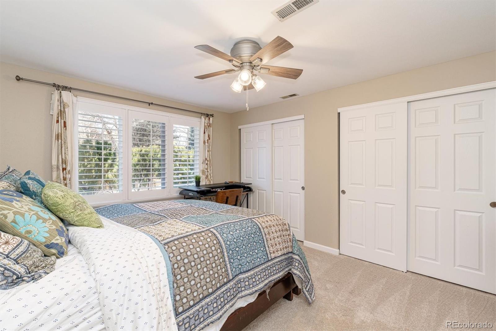6145 South Eudora Way Centennial, CO 80121 - Photo 26 of 33 a bedroom with a bed and a chandelier