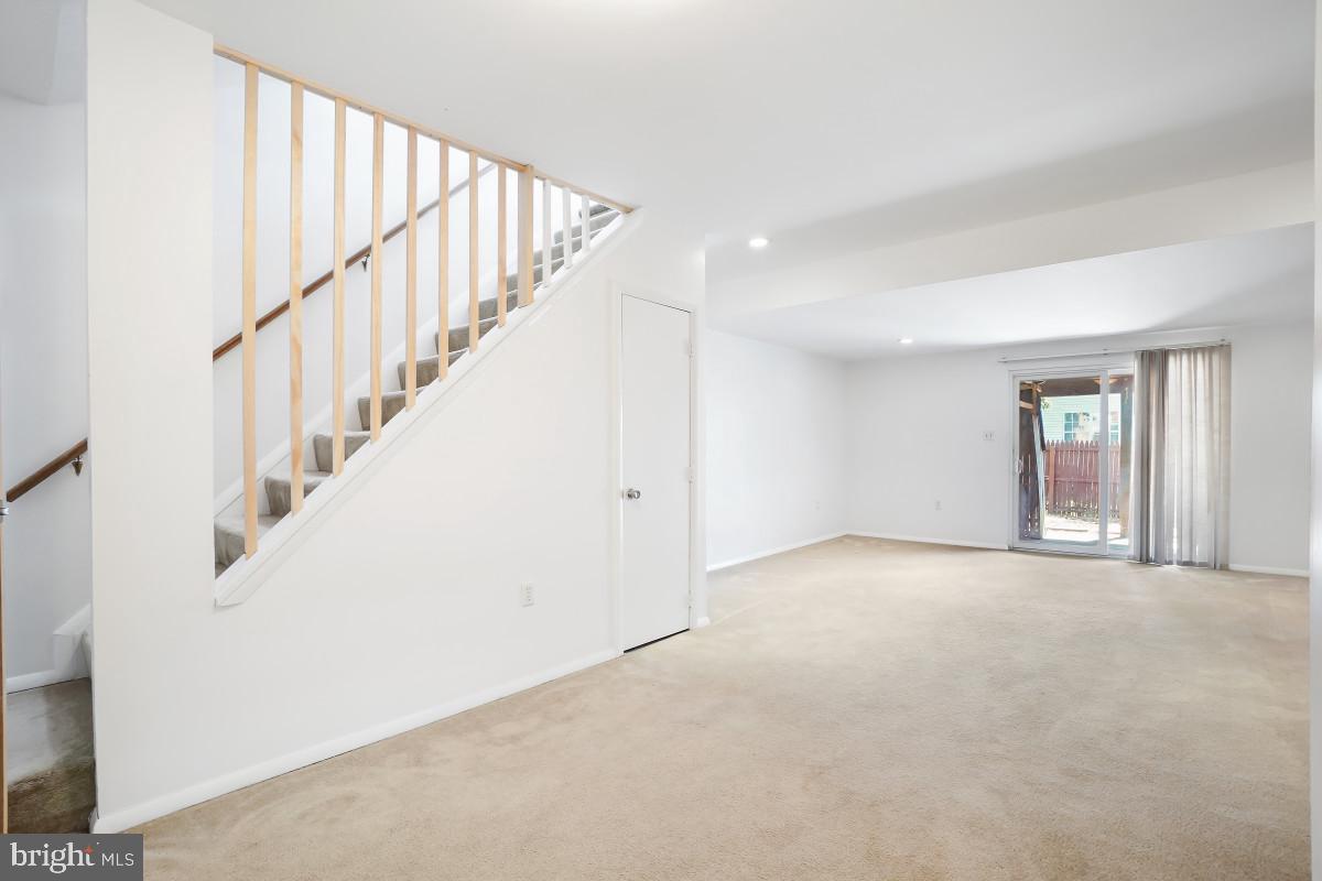 35 Bellfalls Way Nottingham, MD 21236 - Photo 25 of 30 a view of an empty room with wooden floor and stairs