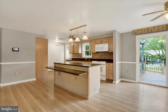 a kitchen with a refrigerator and a stove top oven