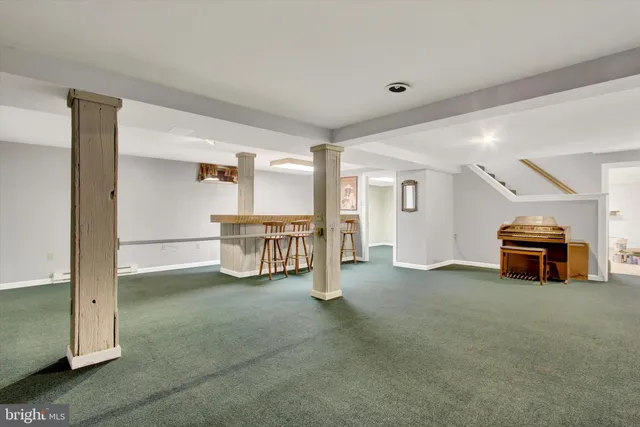 a view of staircase with furniture and window