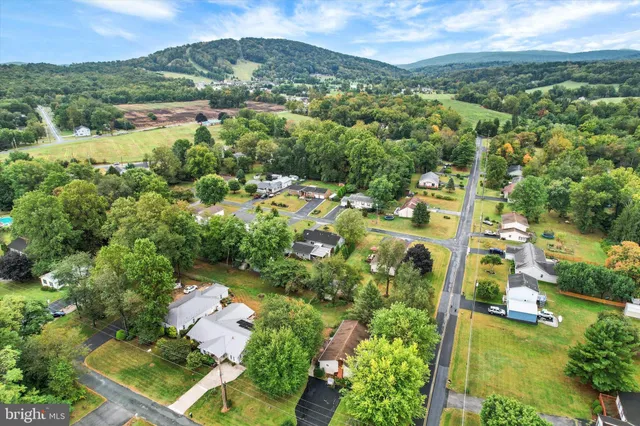an aerial view of residential house with outdoor space and swimming pool