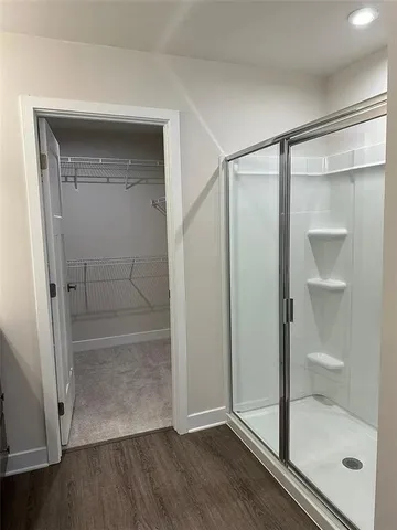 a bathroom with a glass shower door