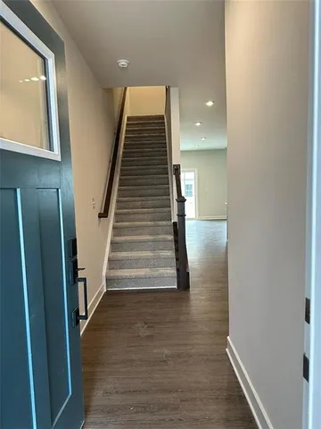 a view of entryway and hall with wooden floor
