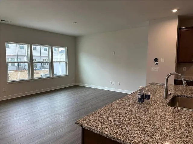 a kitchen with granite countertop a sink a stove and a granite counter tops