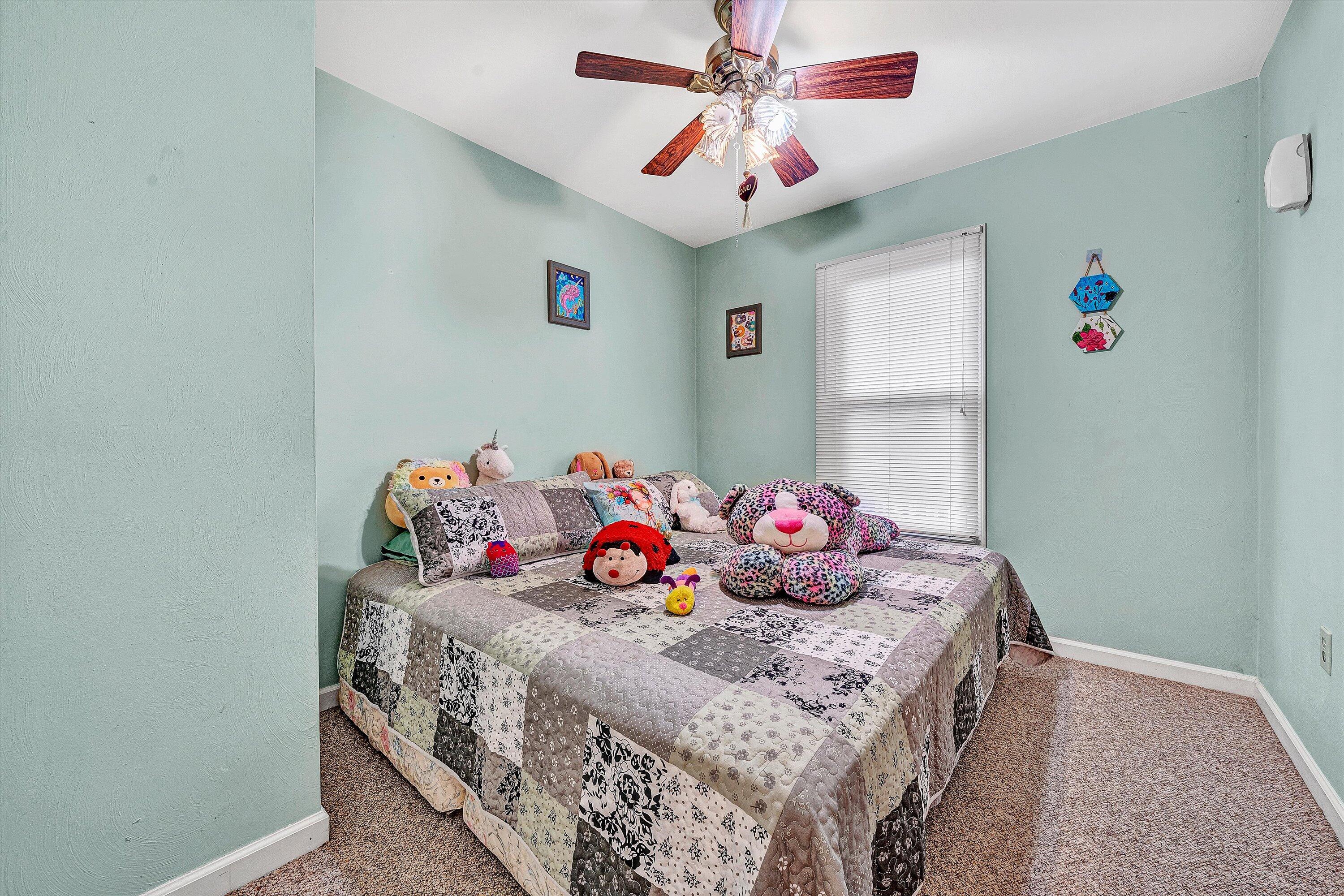 117 Country Lane Thaxton, VA 24174 - Photo 13 of 35 a bedroom with a bed and a chandelier