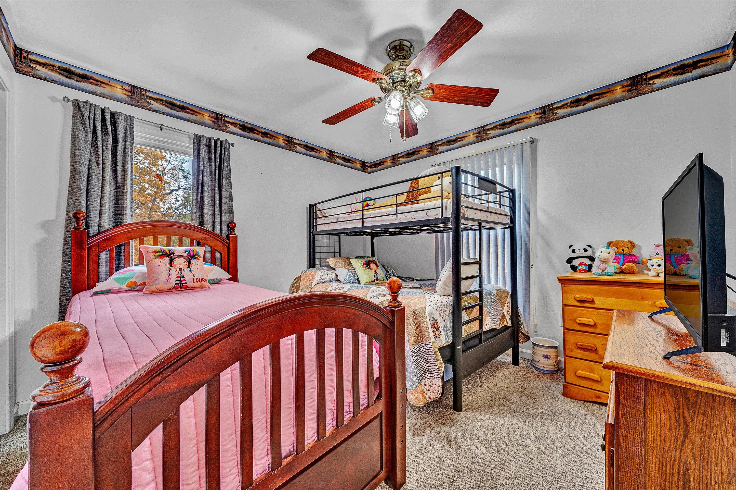 117 Country Lane Thaxton, VA 24174 - Photo 15 of 35 a bedroom with furniture and a chandelier