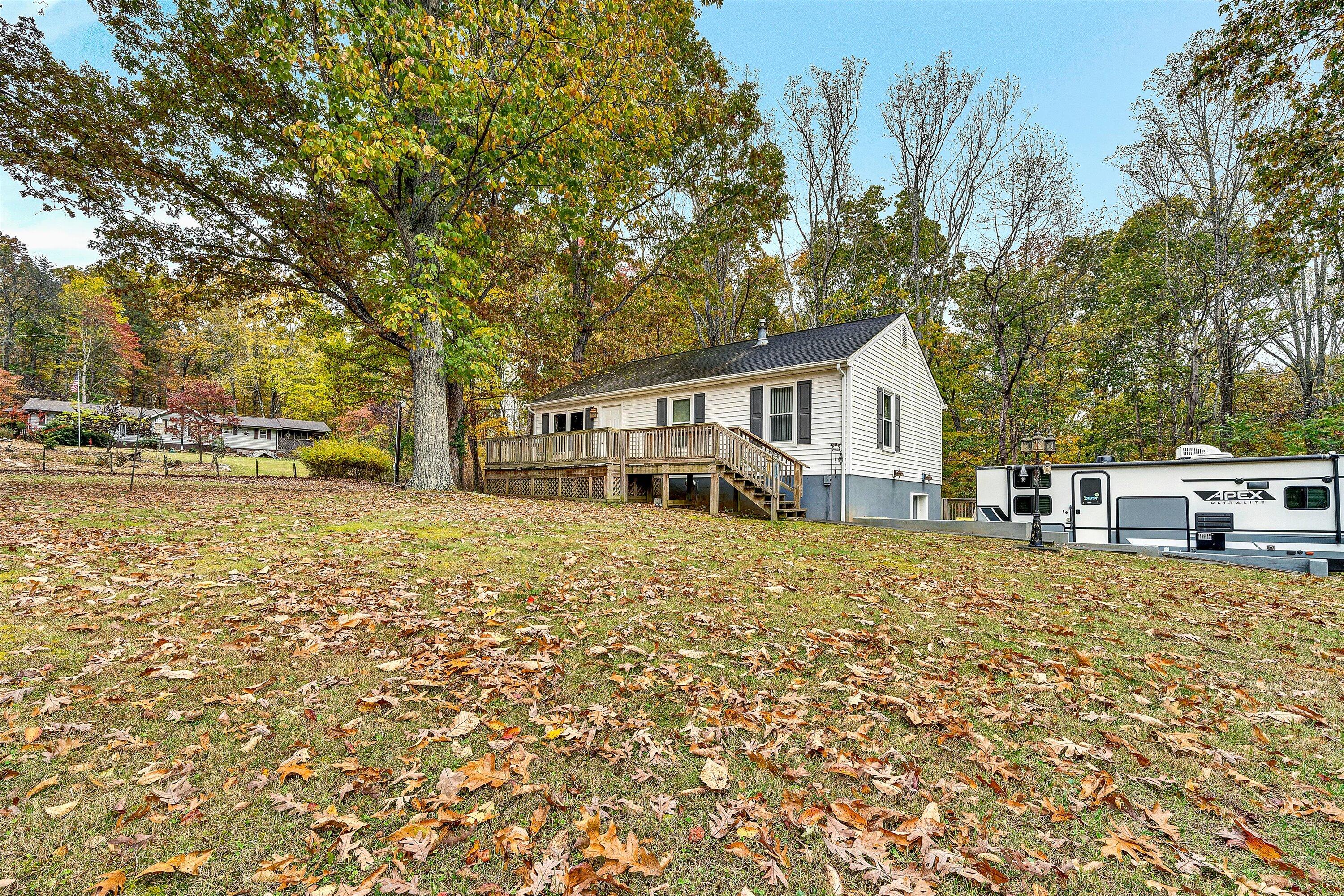 117 Country Lane Thaxton, VA 24174 - Photo 2 of 35 a house with trees in front of it