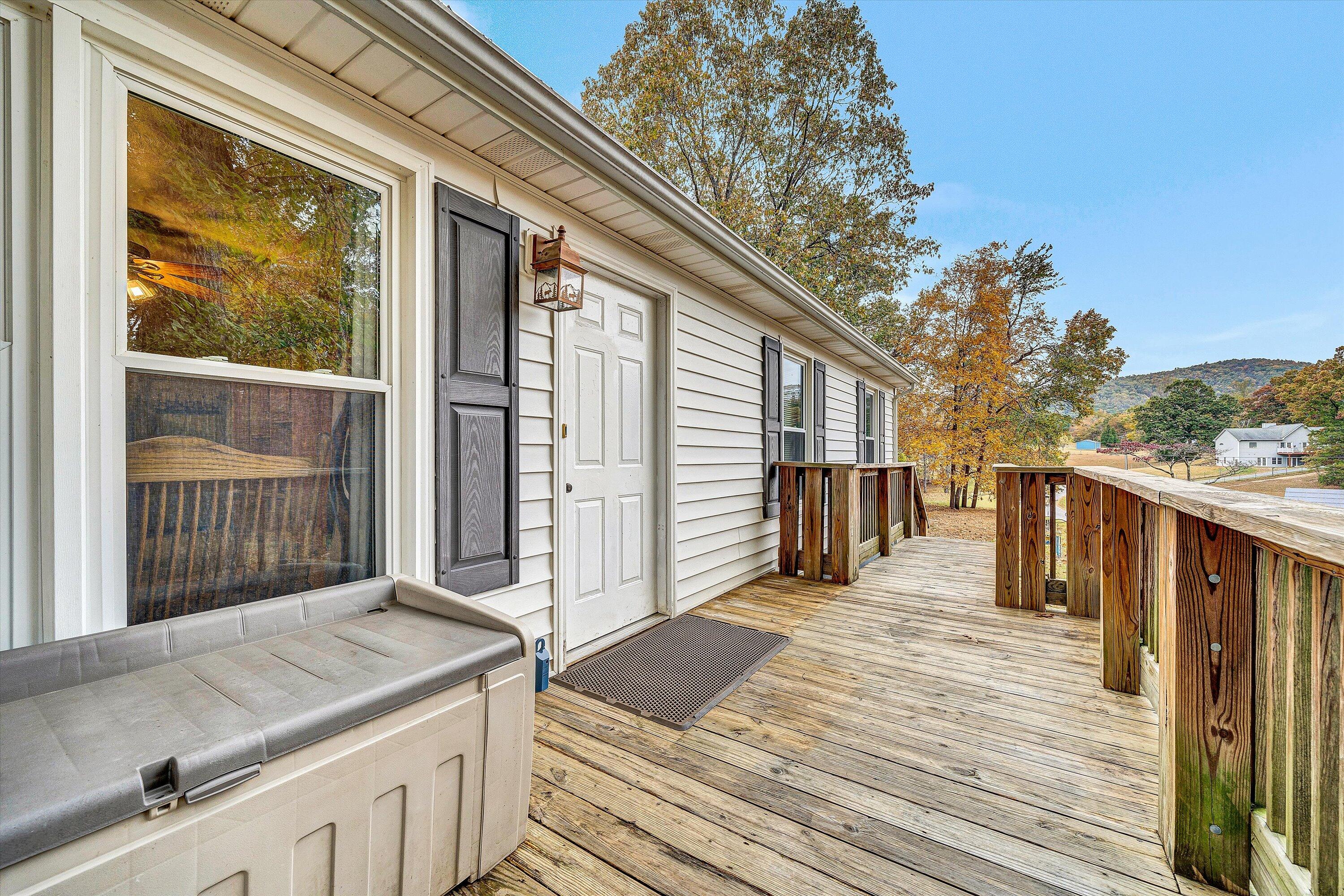 117 Country Lane Thaxton, VA 24174 - Photo 4 of 35 a view of a balcony with wooden floor and fence