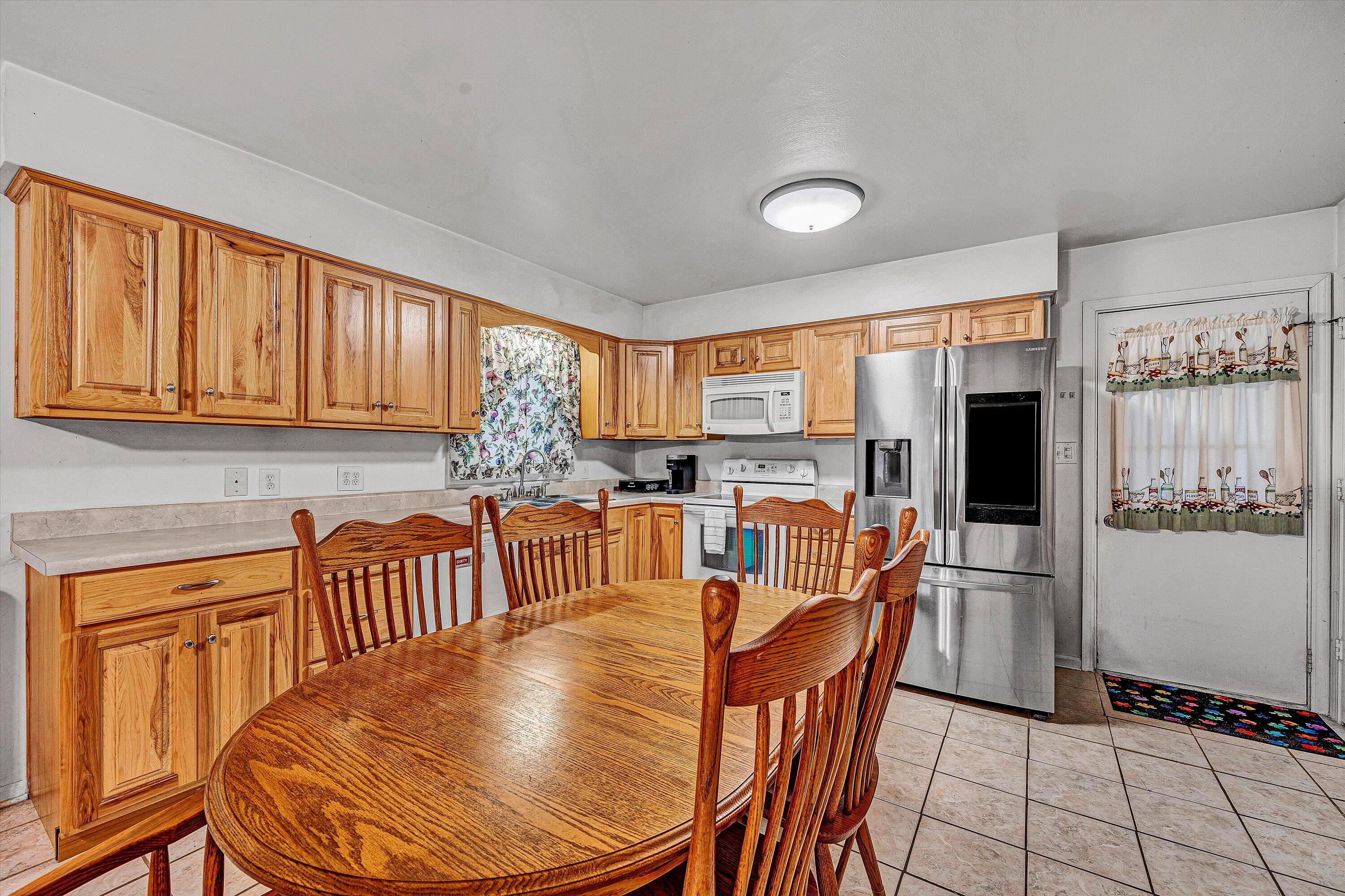 117 Country Lane Thaxton, VA 24174 - Photo 10 of 35 a kitchen with stainless steel appliances granite countertop a dining table chairs refrigerator and sink