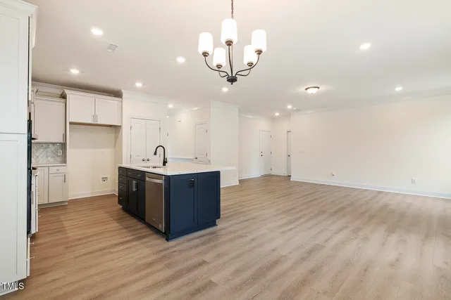 a kitchen with stainless steel appliances granite countertop a sink and a refrigerator