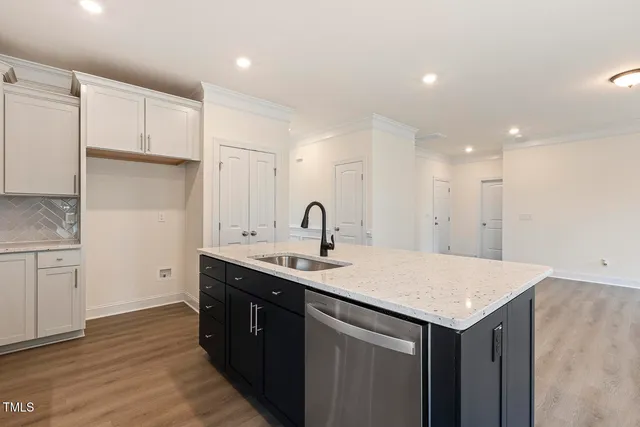 a kitchen with a sink and cabinets