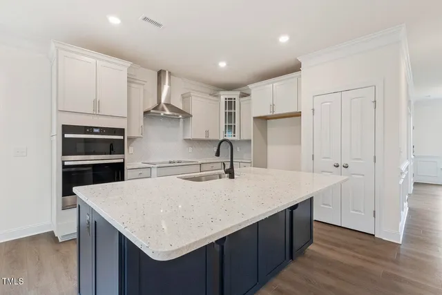 a kitchen with stainless steel appliances a sink and a refrigerator