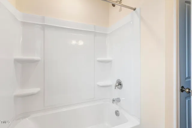 a bathroom with a bathtub and a toilet