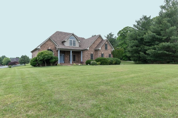 3003 Burts Crossing Springfield, TN 37172 - Photo 1 of 48 a front view of a house with a yard and garage