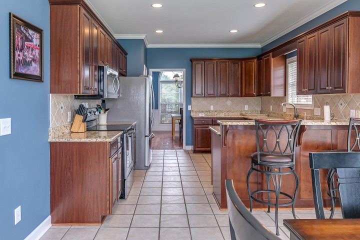 3003 Burts Crossing Springfield, TN 37172 - Photo 15 of 48 a kitchen with stainless steel appliances granite countertop a refrigerator a sink dishwasher a stove top oven and a center island