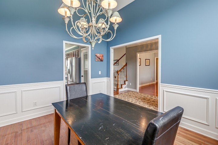 3003 Burts Crossing Springfield, TN 37172 - Photo 10 of 48 a view of a dining room with furniture a chandelier and wooden floor