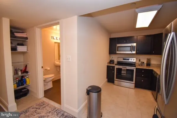 a kitchen with stainless steel appliances kitchen island granite countertop a refrigerator and a stove