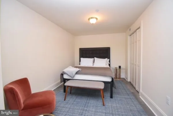 a bedroom with a bed and a chair