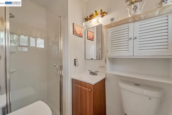 a bathroom with a sink a toilet and mirror