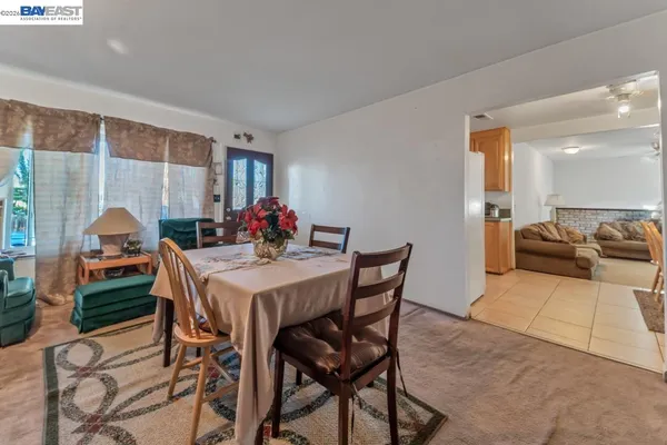 a view of a dining room with furniture and a potted plant