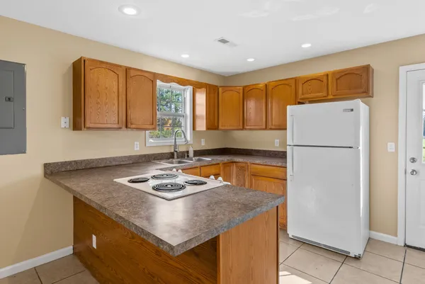 a kitchen with a refrigerator a stove a sink and a refrigerator