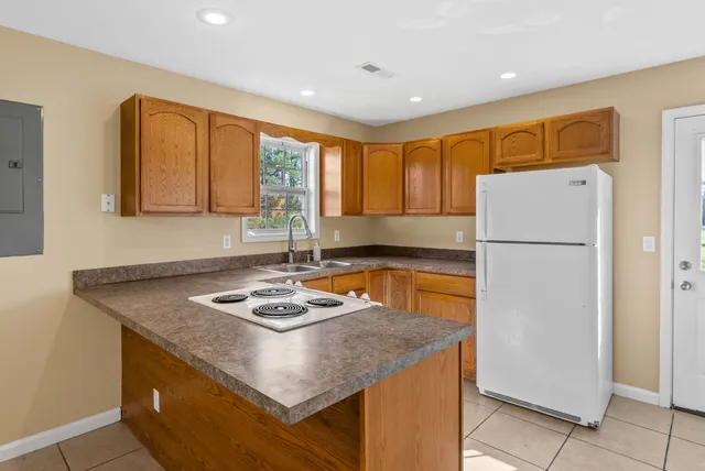 a kitchen with a refrigerator a stove a sink and a refrigerator