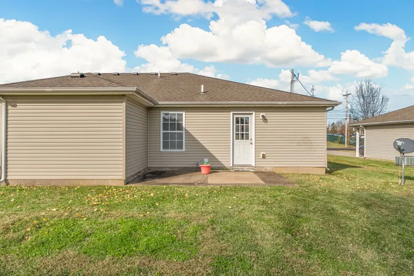 a backyard of a house with table and chairs