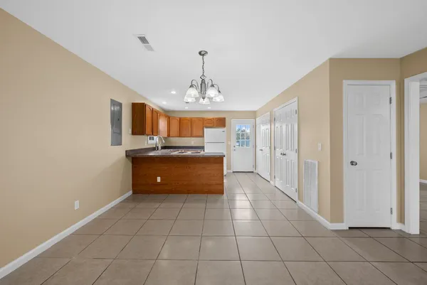 a large kitchen with a sink and cabinets